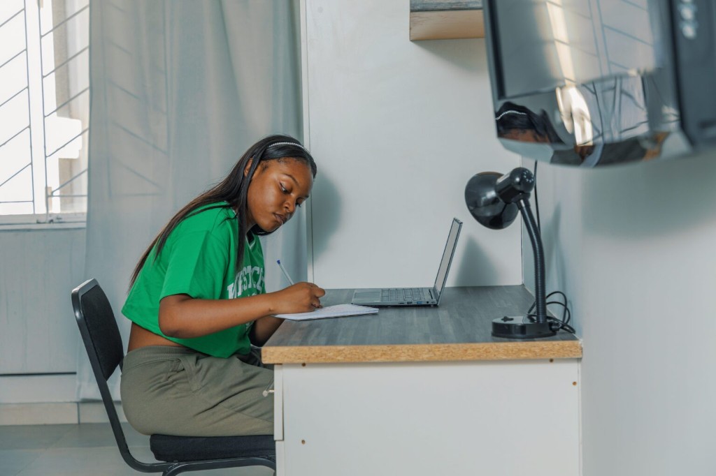Student studying at a desk in a Winco Residence room