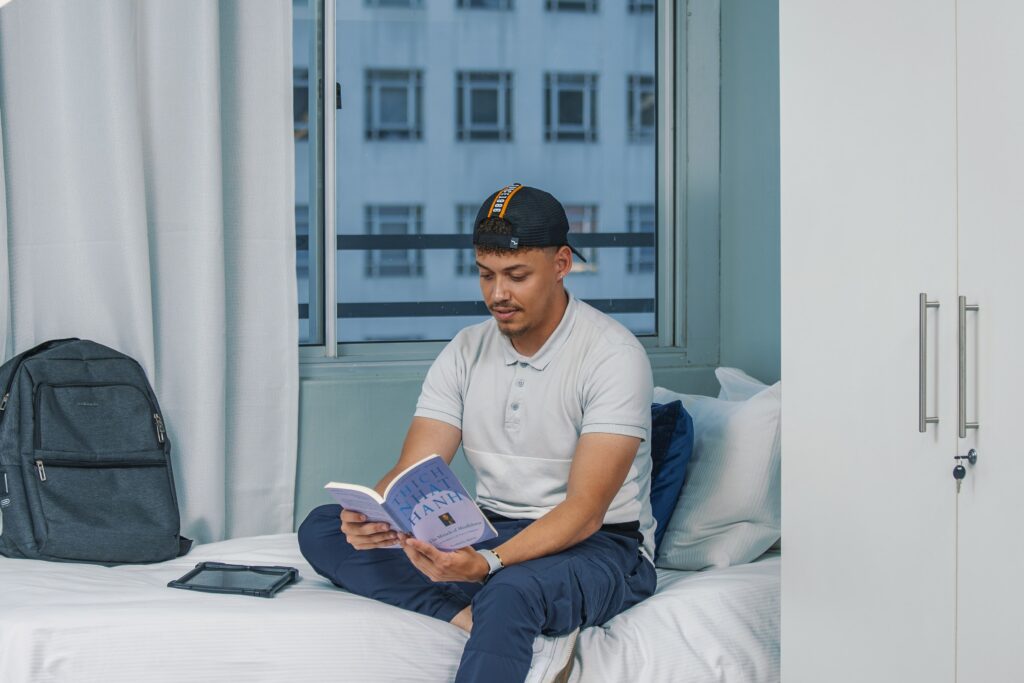 Student reading in a Winco Residence room